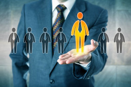 Recruitment agency-businessman holding holographic people